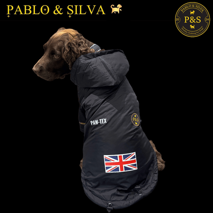 Dog wearing the Pablo & Silva waterproof winter jacket with a British flag patch, branded 'Pablo & Silva' on a black background.