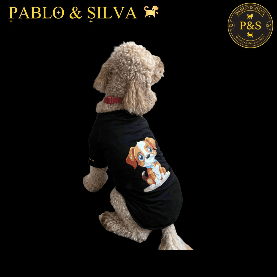 Dog wearing the black t-shirt with a graphic design, standing on a black background with 'Pablo & Silva' branding.