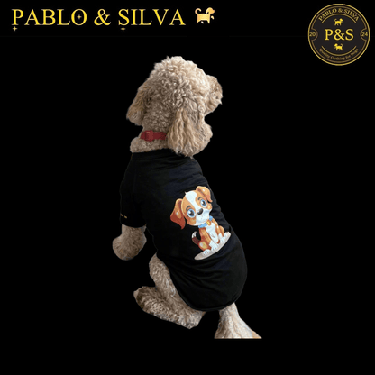 Dog wearing the black t-shirt with a graphic design, standing on a black background with 'Pablo & Silva' branding.